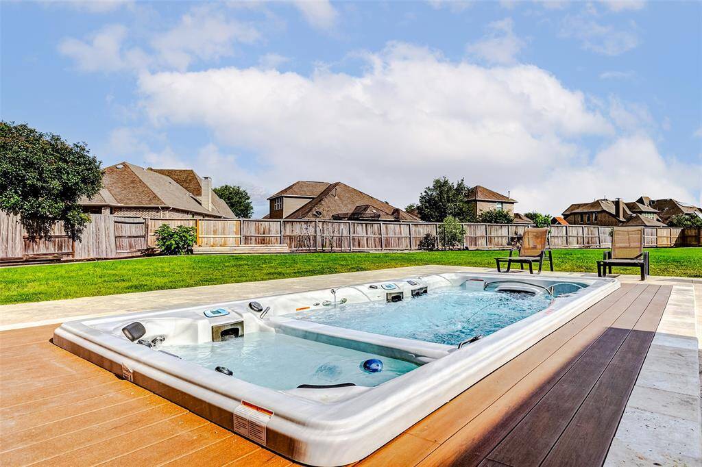 This premium Master Spas swim spa offers the best of both worlds with two separate bodies of water—an inviting hot tub on one side and a swim spa on the other. It’s the perfect combination of fitness, fun, and relaxation, all in your own backyard retreat.