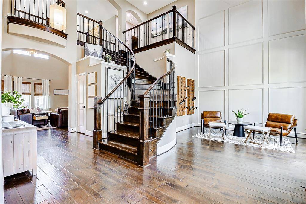 Step inside to find sweeping wood floors, soaring two-story ceilings, and designer-curated paint selections—all coming together to deliver a grand and unforgettable first impression.