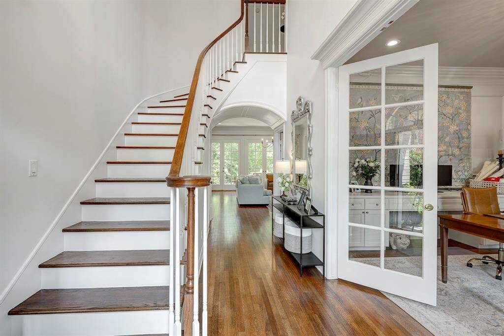 Foyer has 20ft ceiling and pretty arched mouldings leading to the family room