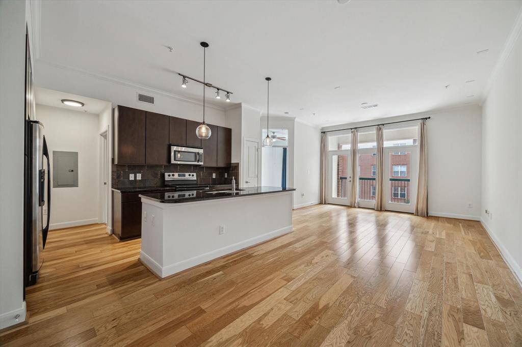 Open floorplan with double pane French doors newly painted 2025