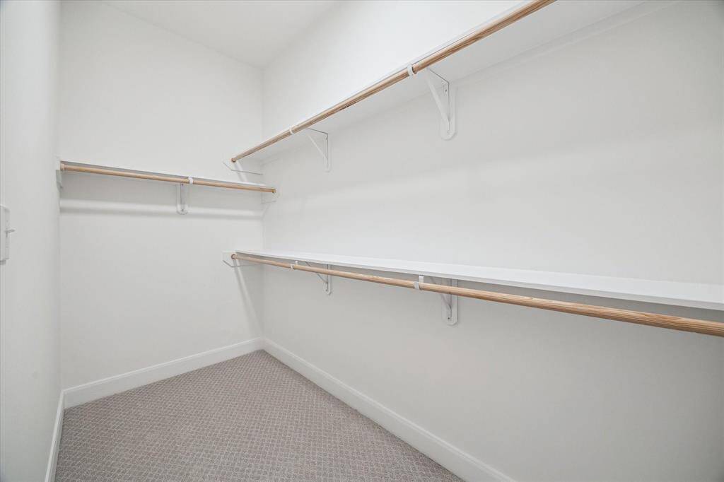 Primary walk-in closet w plenty of storage