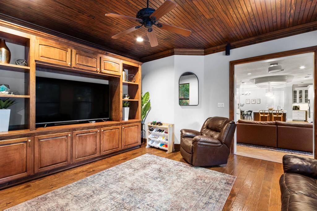 Game room  off the kitchen and patio features rich wooden cabinetry with a built-in entertainment center.