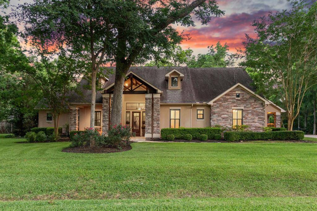 Elegant 4/3.5/3 custom one story home with pool and outdoor patio/kitchen is nestled among mature trees. Open plan with expansive windows creating a seamless connection between the indoors and outdoors. Perfect for entertaining!