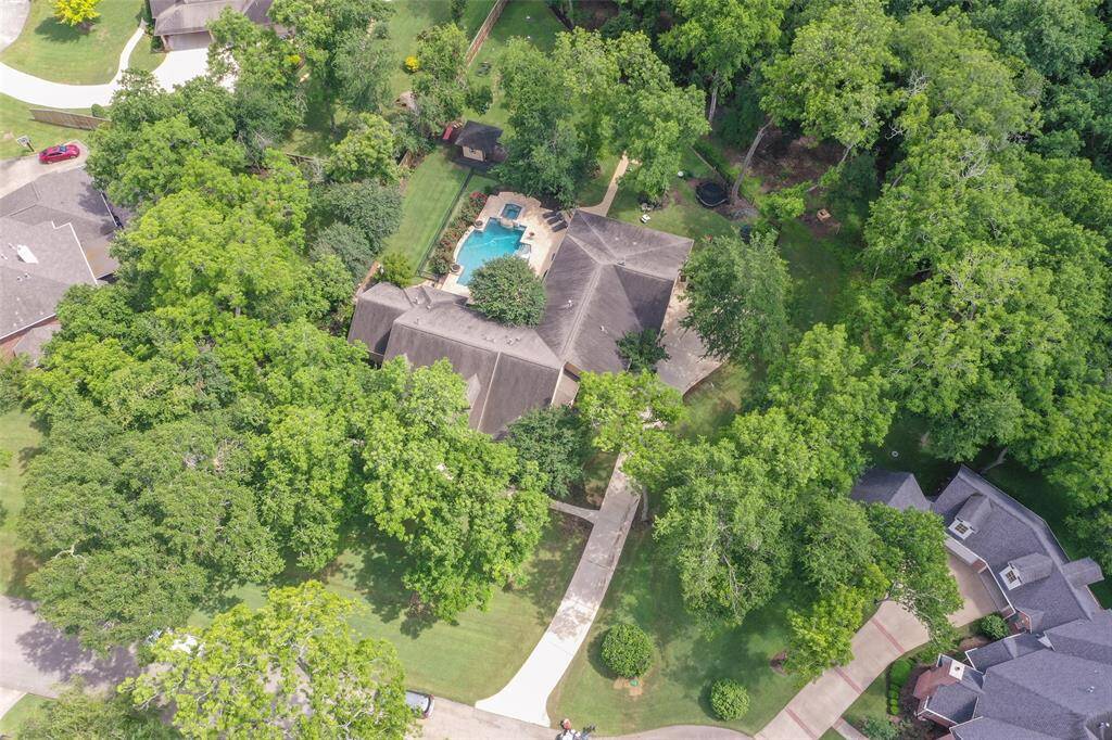 The property is nestled in a wooded area, providing privacy, and is part of a gated prestigious neighborhood with custom homes. Yet you can enjoy the convenience of 5 cities within minutes.  Great LCISD schools.