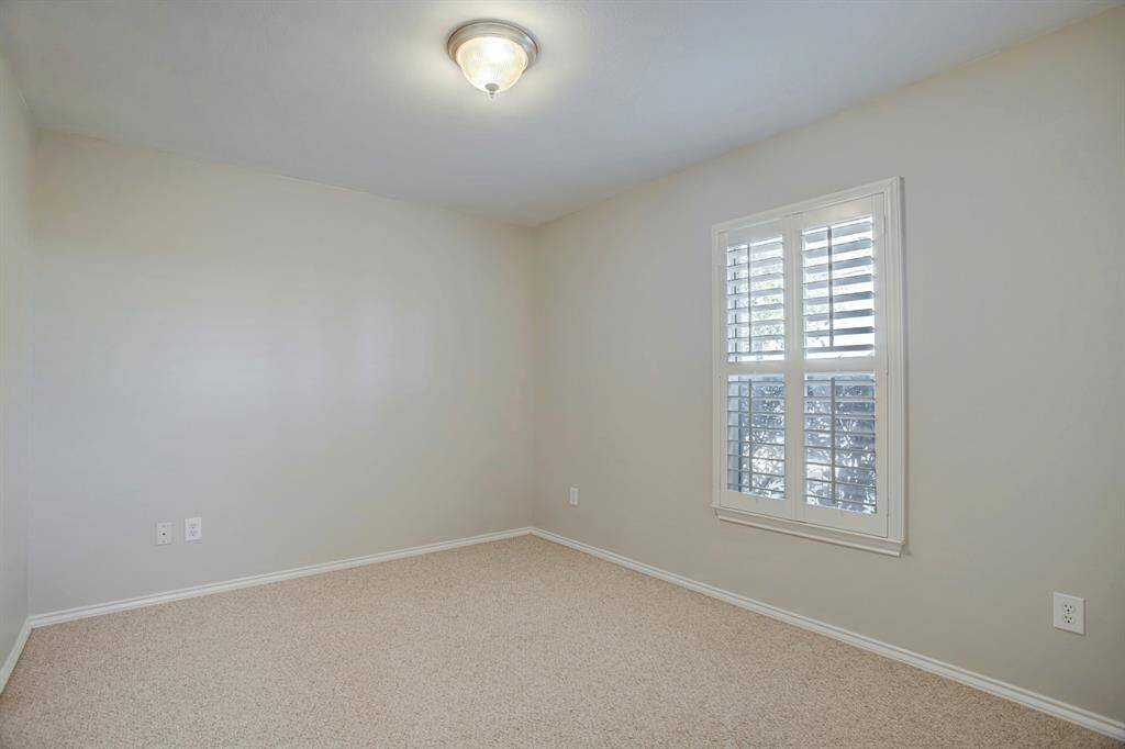 Bedroom on the first floor will accommodate a queen bed; complete with plantation shutters and a roomy closet.