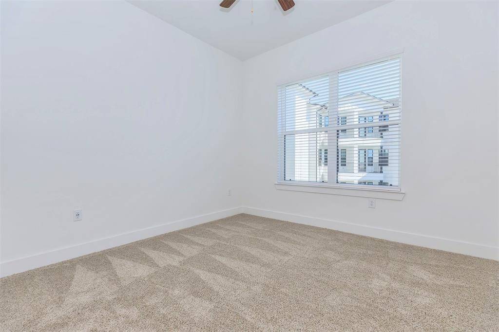 Primary bedroom with large window and ensuite bath