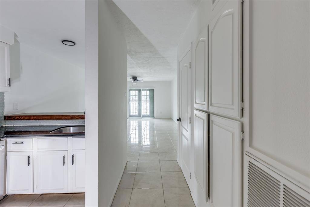 Storage and pantry in entry hall off the kitchen includes a pantry space.