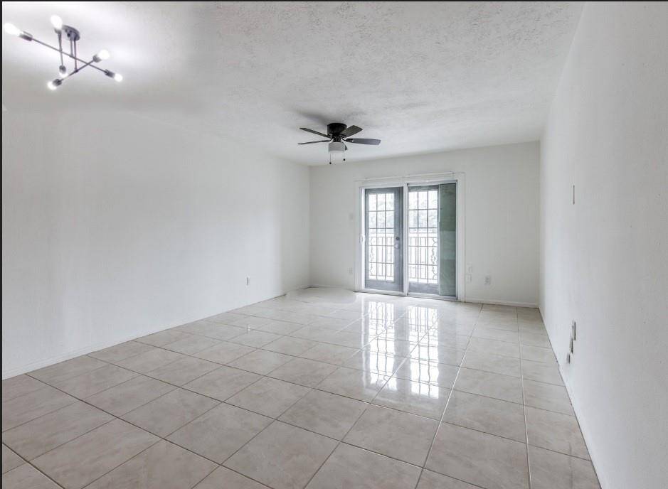 A distinctive light fixture adds ambience in the dining area that opens to the living space.