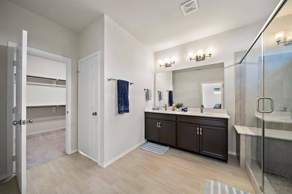Bath with walk-in shower, bench, dual vanities, dual shower heads and bench!