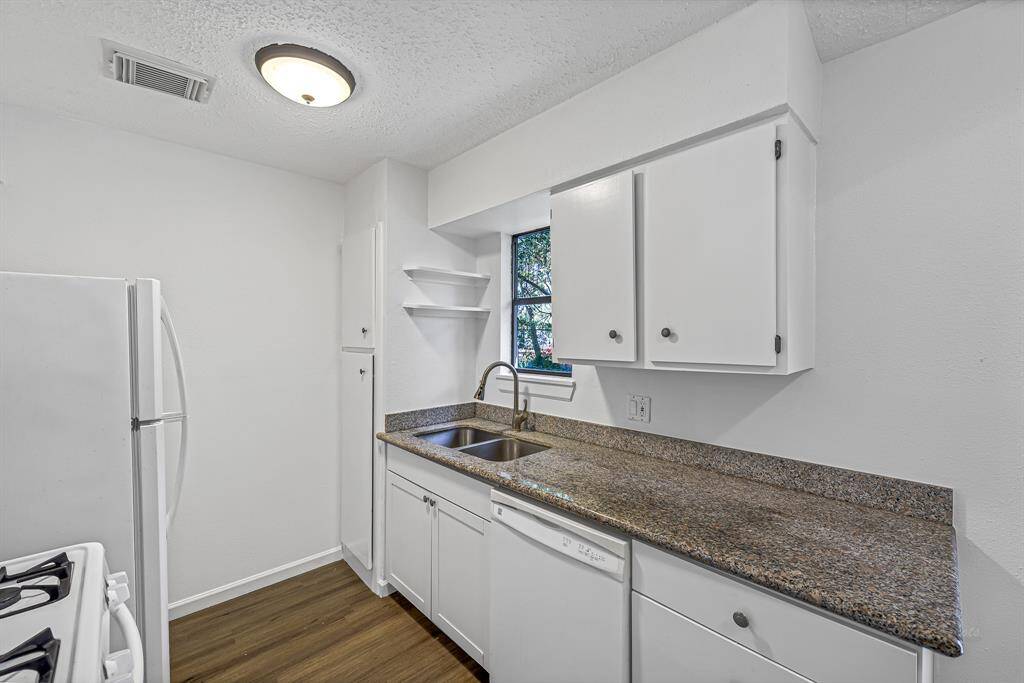 Kitchen looks out to the back green space.