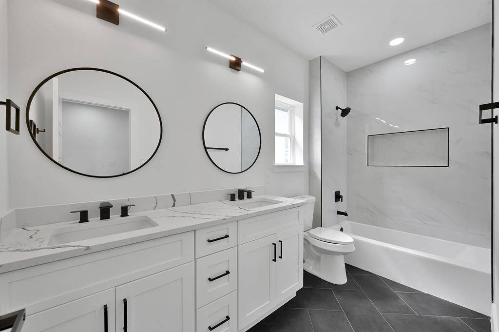 Secondary full bath with tub and dual sinks