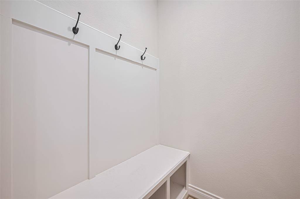 and a convenient drop zone with built-in storage and coat hooks near the two-car attached garage offering ample space for parking and additional storage.