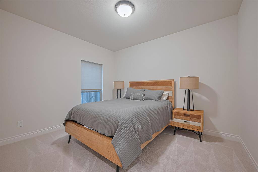 Two additional well-appointed bedrooms feature walk-in closets and share a full bathroom with a tub/shower combination—perfect for guests or family members.