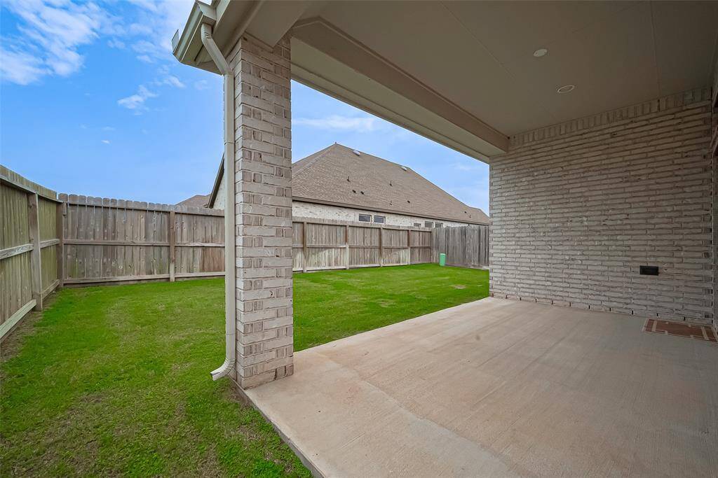 Step outside to the extended covered patio, an inviting outdoor space ideal for morning coffee, evening relaxation, or weekend entertaining.