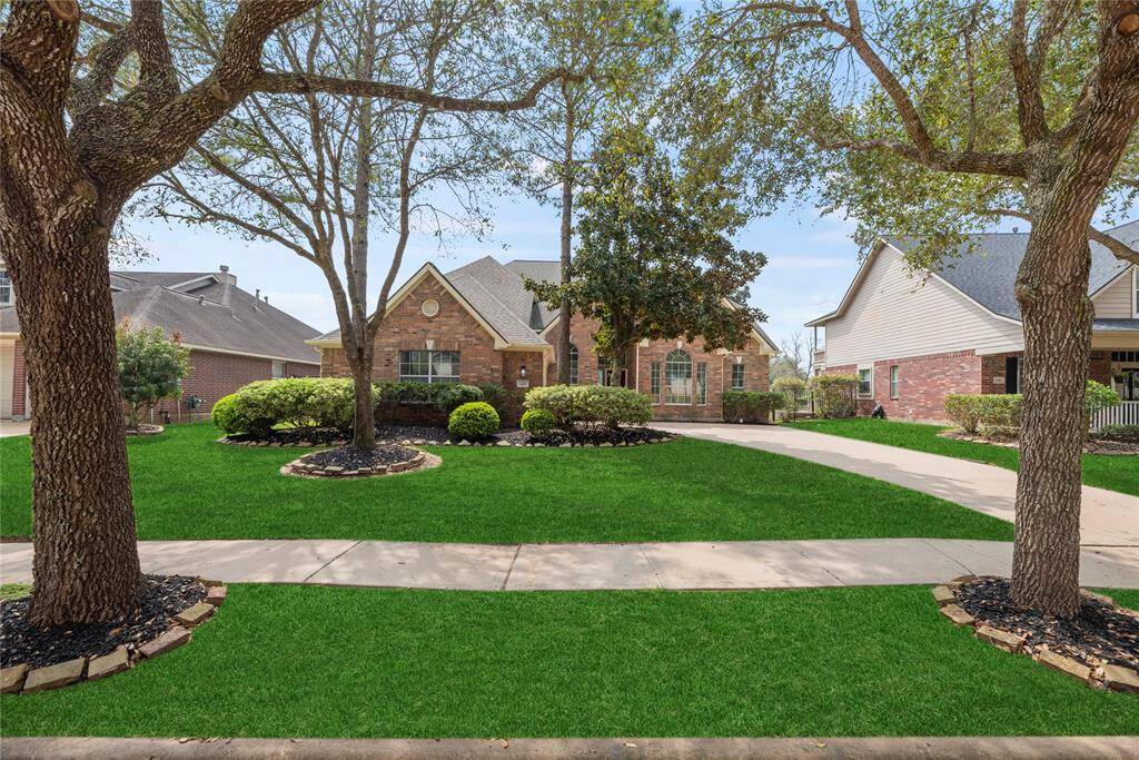 Finely crafted, the elegantly appointed brickwork entices the senses, while the charming stone-bordered flower beds add color and texture to the exterior.