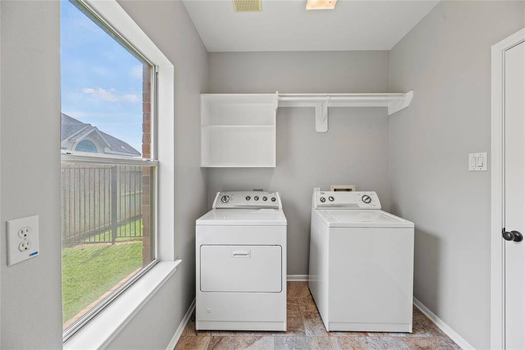Boasting a laundry room with a hanging bar and a shelf, there is a load of room for cleaning supplies and clothing organization.