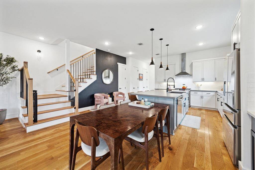 Spacious kitchen, dining and living area with reclaimed wood floors.