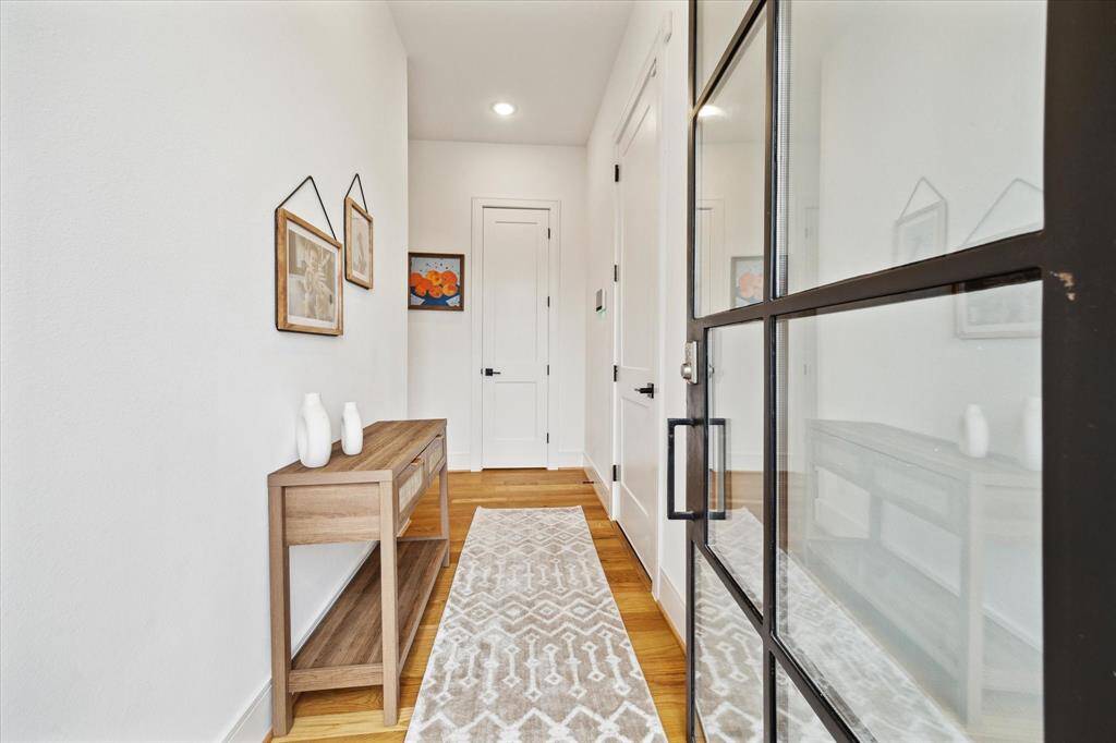 Side entry with steel door, hallway access to the front door and garage.