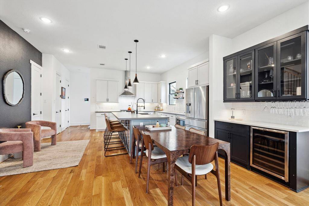 Spacious kitchen with dry bar, wine refrigerator, and dining area.