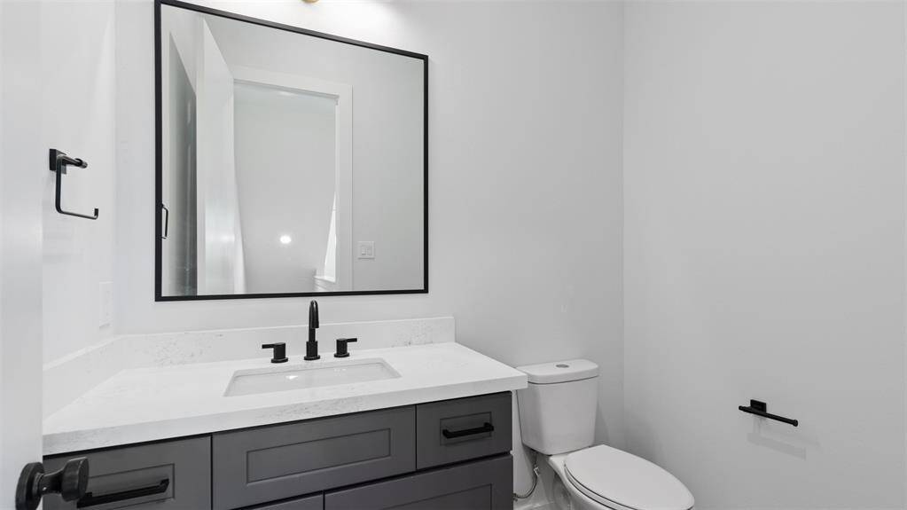 The half bathroom has modern features.