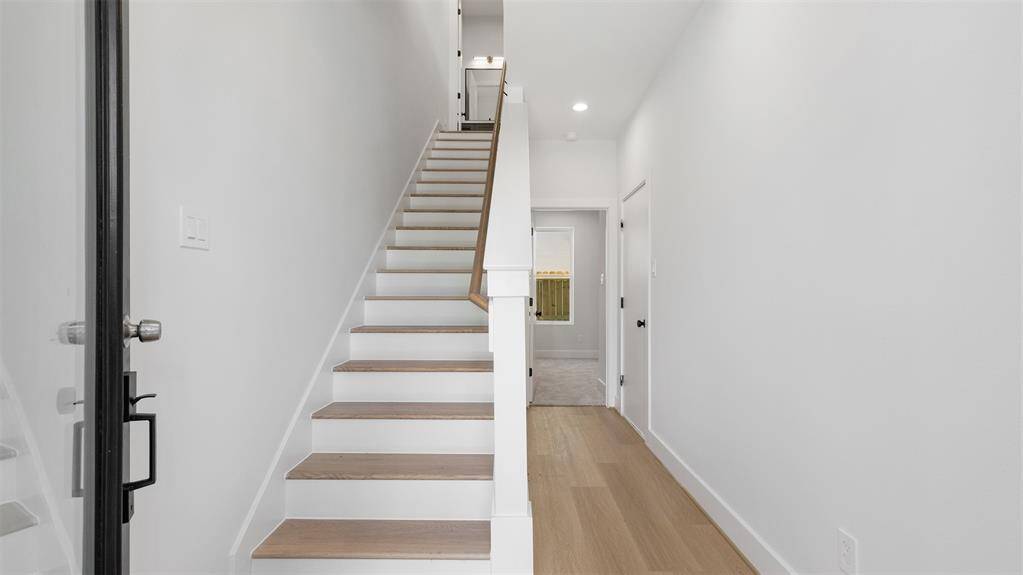 Upon entering is the staircase to the second floor and first floor bedroom.