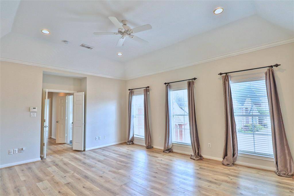 Luxurious primary bedroom with abundant natural light and ample space for relaxation.