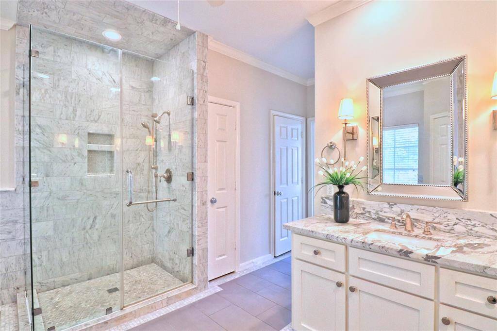 Luxurious marble shower in the primary bathroom offers seamless elegance.