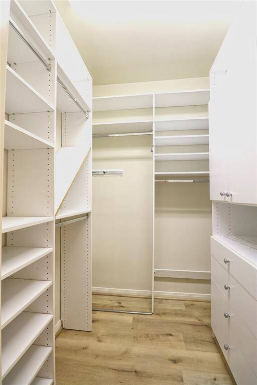 second Spacious walk-in closet in the primary bedroom with ample shelving and storage solutions.
