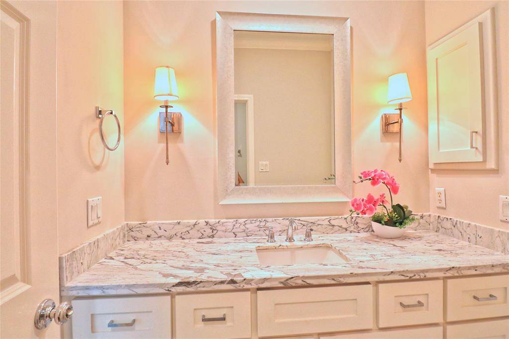 Elegant second-floor  full bathroom with a marble countertop, conveniently shared by two bedrooms.