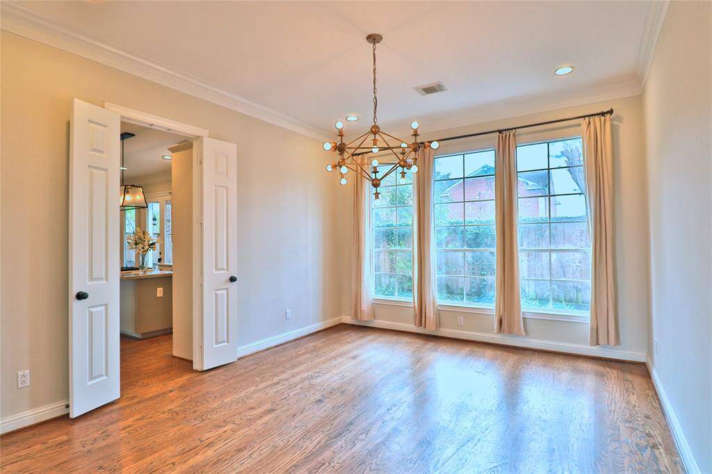 Elegant dining room with expansive windows for abundant natural light.