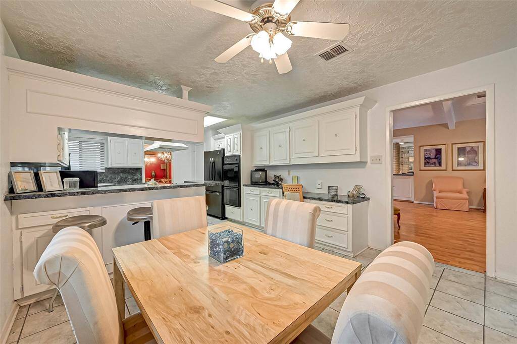 Kitchen cabinets are accented by crown molding.