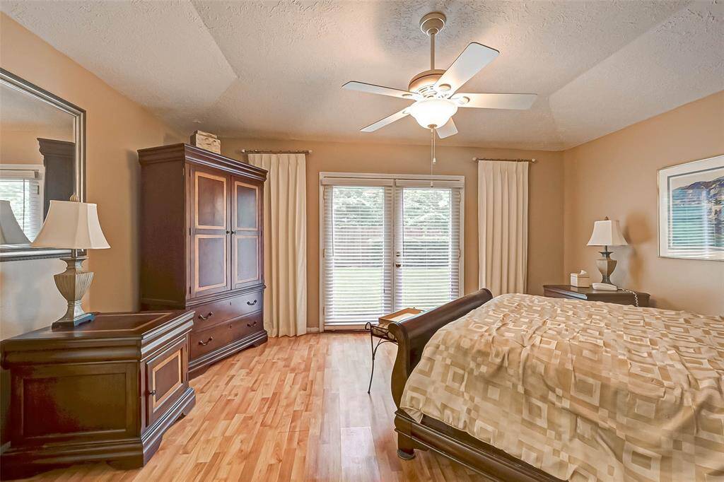 Coffered ceiling in master bedroom with a ceiling fan.