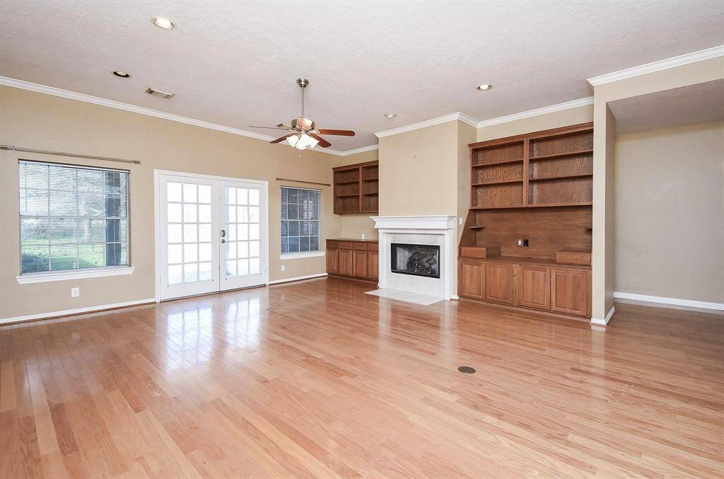 An expansive living space with beautiful hardwood flooring and an open layout, offering versatility and comfort for any lifestyle