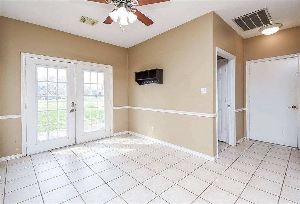 A sunlit breakfast nook with direct access to the side patio and shady side yard, creating the perfect space to start the day with a cup of coffee.