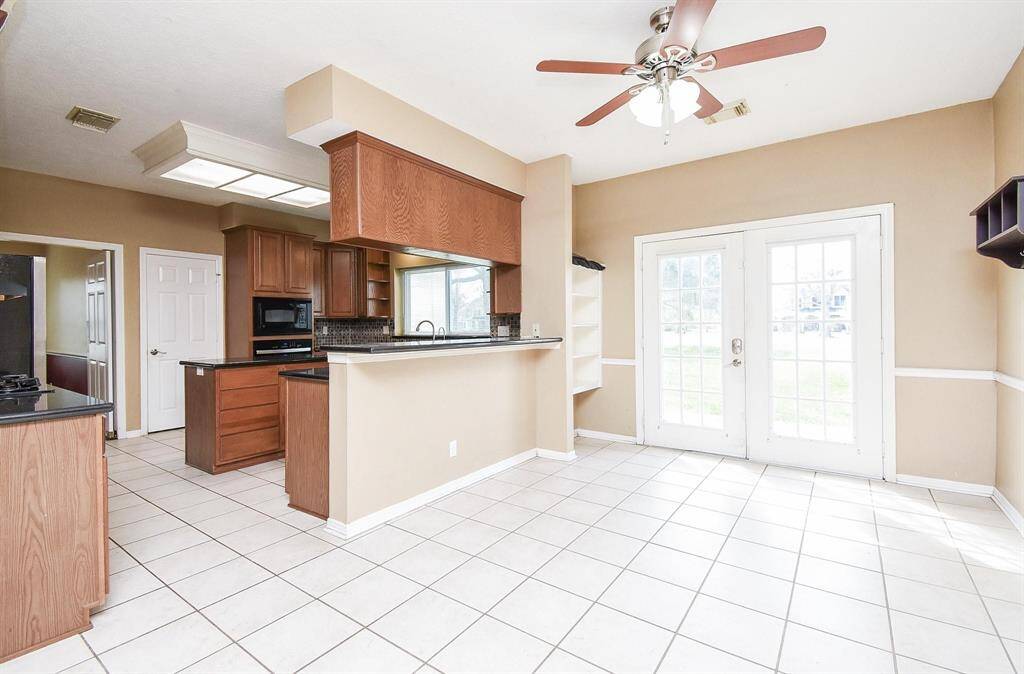 A bright and airy kitchen space with modern fixtures, ample storage, and a charming breakfast bar for casual dining