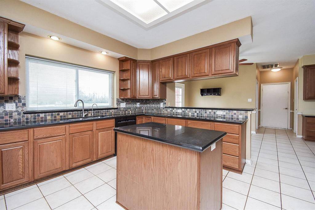 A well-appointed kitchen with casual seating and a large center island that provides additional prep or serving space.