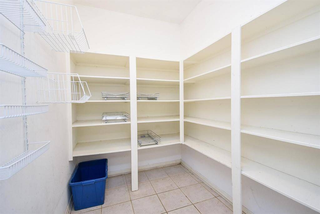 A spacious pantry with ample shelving and organized storage, making meal prep and grocery organization effortless.