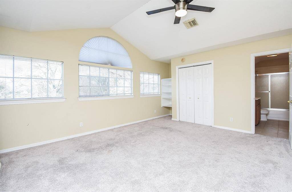 An open and inviting living space with high ceilings, large windows, and elegant architectural details for a bright and airy feel.
