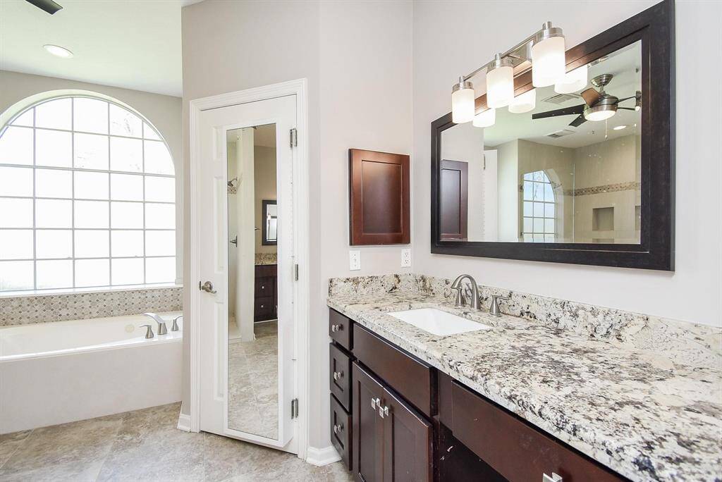 A luxurious  bathroom with a double vanity, elegant fixtures, and a sophisticated design for ultimate comfort