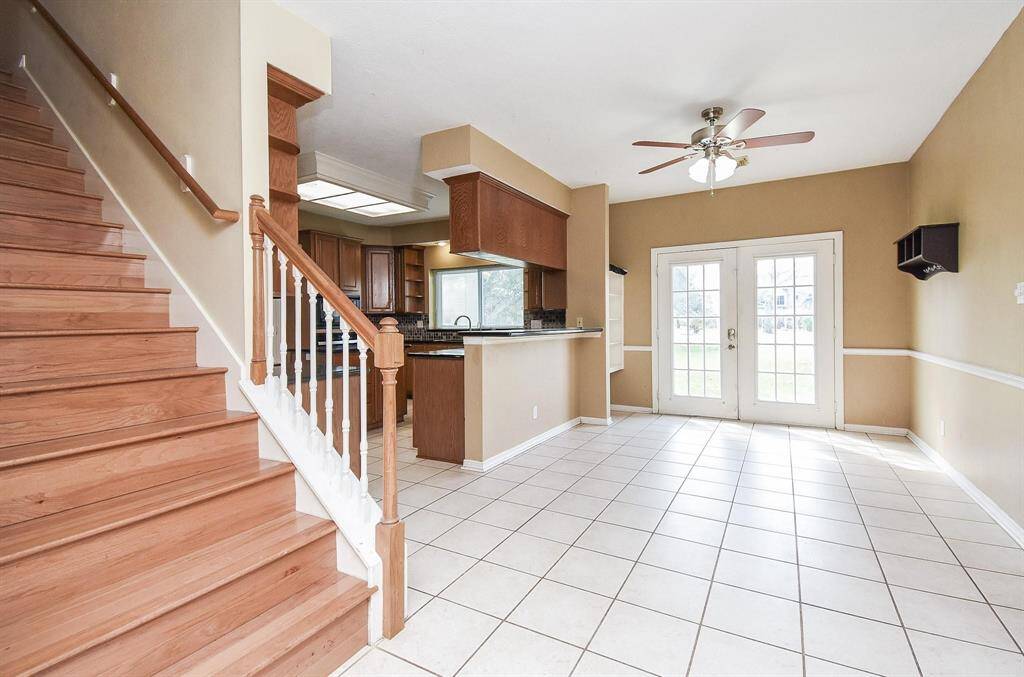 A grand staircase and an open-concept layout make this bright and airy foyer the perfect introduction to the home’s elegant interiors.