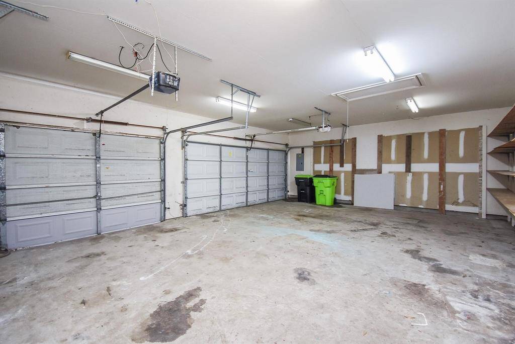 A spacious two/three-car garage with a clean and well-maintained interior, offering ample storage and workspace options