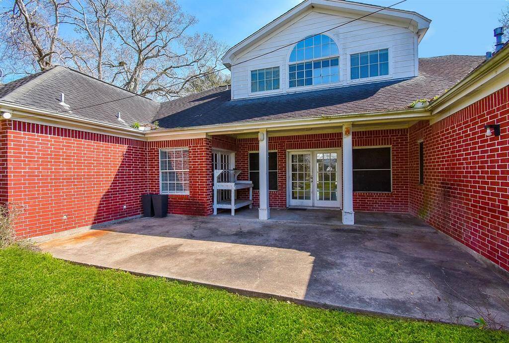 A rear view of the home featuring a covered patio area, perfect for outdoor relaxation and gatherings.