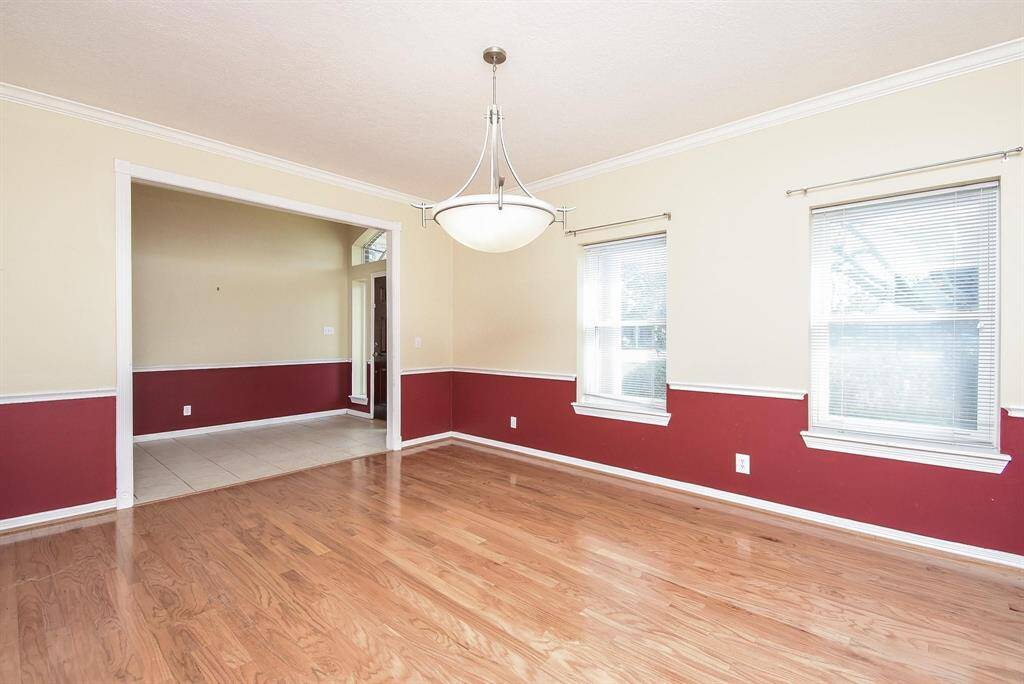 A bright and spacious dining room with elegant wainscoting, perfect for hosting intimate dinners and special occasions