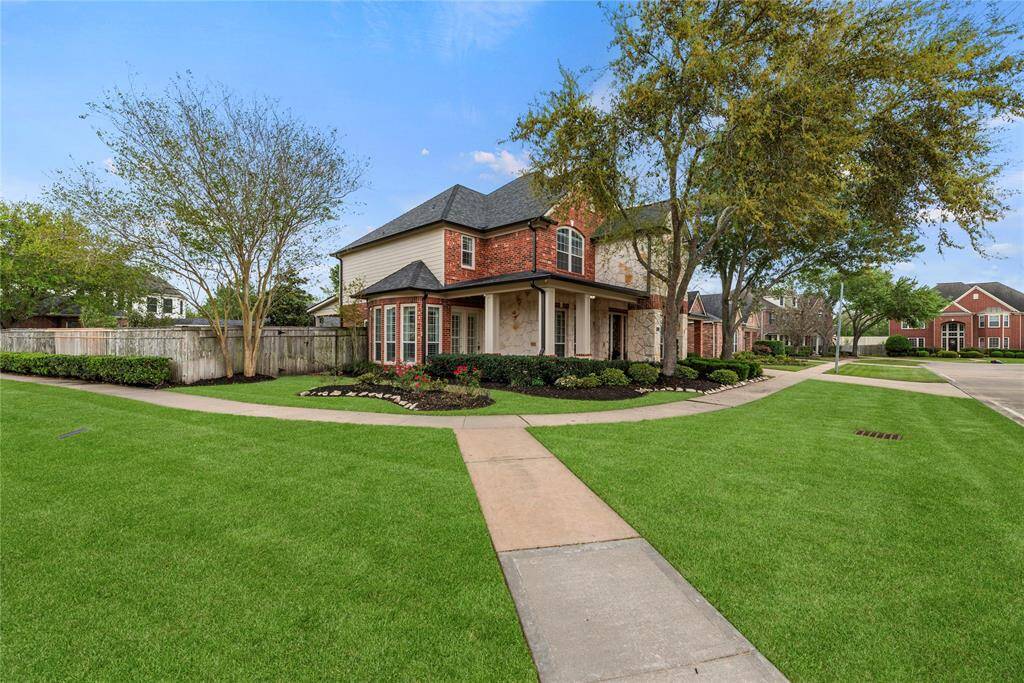 Finely crafted, the elegantly appointed brickwork entices the senses, while the charming stone-bordered flower beds add color and texture to the exterior.