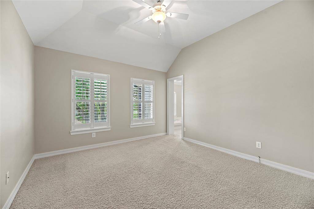 High ceilings with interesting angles provide a unique quality, while the neutral carpet contributes a fantastic backdrop for a variety of style preferences.