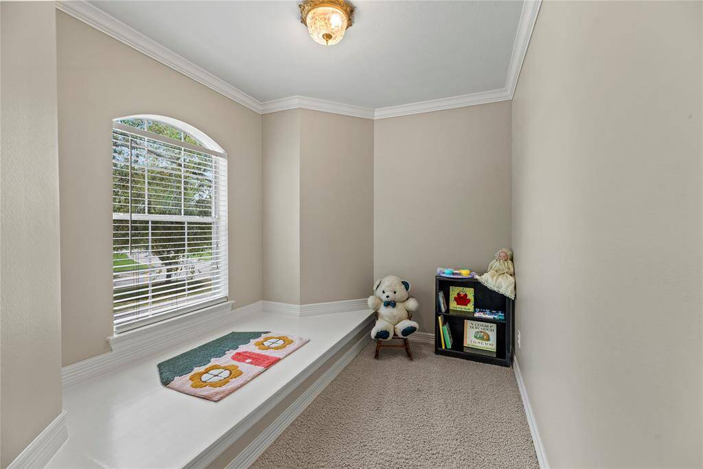 A cozy, tucked-away playroom adjoins the bedroom, offering a fun and functional space for creativity and play.