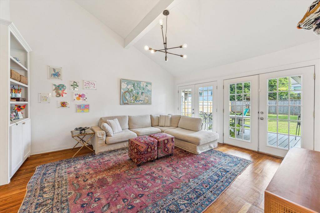 Family room with French doors that lead to a pergola covered porch.