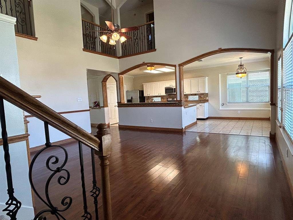 Large open bright family room with laminate wood floors.