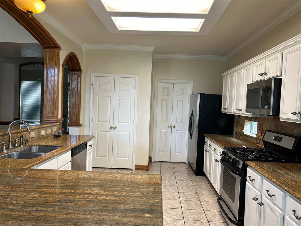 Open Bright Kitchen with stain steel appliances over looking family room.