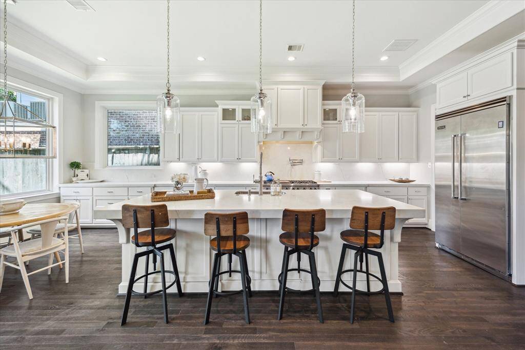 The Chef's Kitchen (20' x 13') is a showstopper. Featuring Viking range and refrigerator, this beautiful space offers an oversized quartz island, top-tier cabinetry, large breakfast area, expansive butler's pantry/bar, walk-in pantry and nearby mudroom. Wow!
